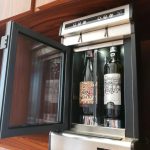 Wineemotion Mia is a refrigerated wine dispenser. It preserves wine by filling the bottle with food grade argon gas. It uses a special tap that pours a precise amount of wine while keeping oxygen away from the wine. Mia features a noiseless fridge, making it ideal for home use. Mia. two bottle wine dispener for home use.